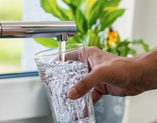 a-person-getting-a-glass-of-water-from-the-tap-rather-than-drinking-bottled-water